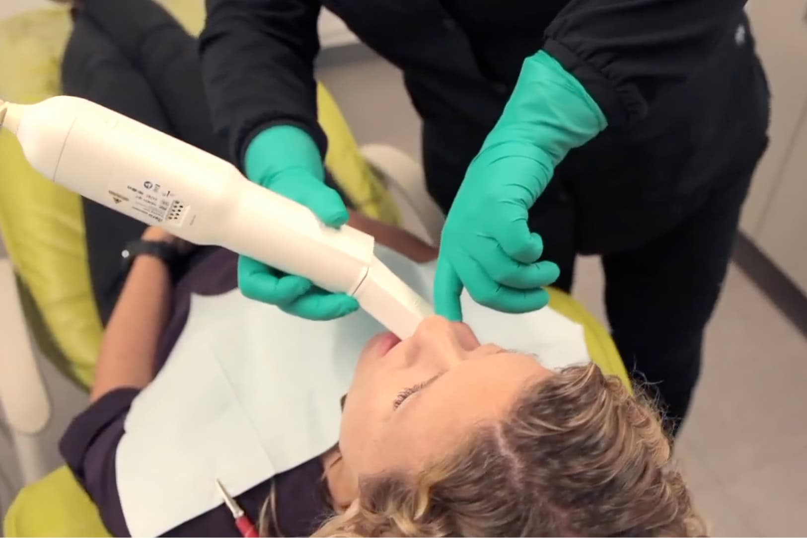 Young patient getting a teeth cleaning treatment